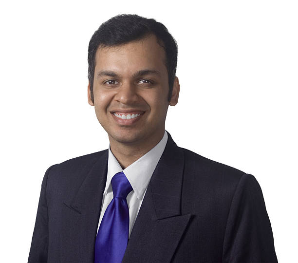 Smiling confident Indian businessman in suit and tie looking at you.